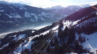 Austrian Alps Cold Mountain Top Snow Mountains Peaks Landscape Drone Aerial Flight drone flyover the mountains and skiing village