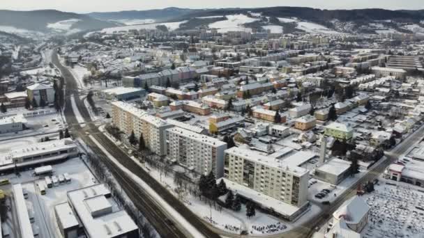 Aerial drone footage flying overlooking housing estates, public parks and commercial properties in a built up area in the small town of Bardejov in Slovakia during winter snowy sunrise, river Topla – Stock-video