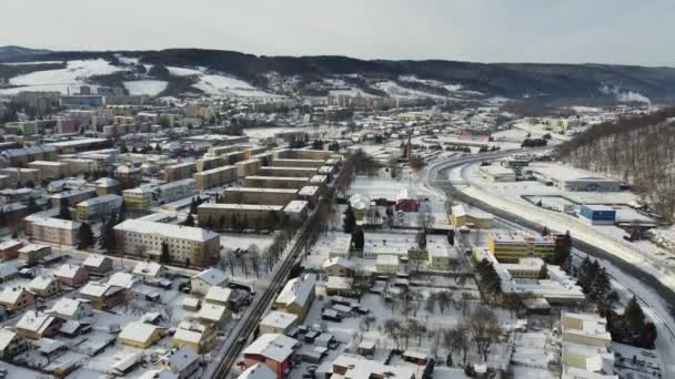 Aerial drone footage flying overlooking housing estates, public parks and commercial properties in a built up area in the small town of Bardejov in Slovakia during winter snowy sunrise, river Topla — Stockvideo