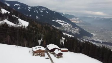 Austrian Alps Cold Mountain Top Snow Mountains Peaks Landscape Drone Aerial Flight drone flyover the mountains and skiing village