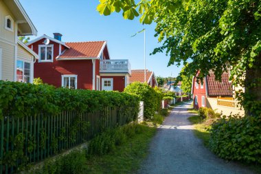 Street view in Sandham, Sweden. Village house, garden and footpath