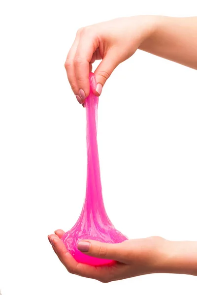 Çocuklar için bir oyuncak sümük ve beyaz arka planda akan sıvı.