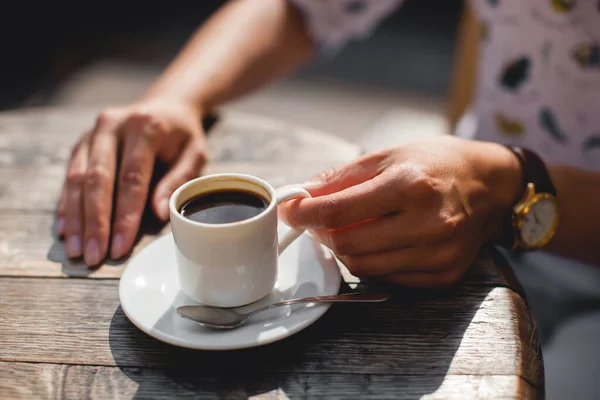 close up mug of delicious fragrant coffee on the table in the hands