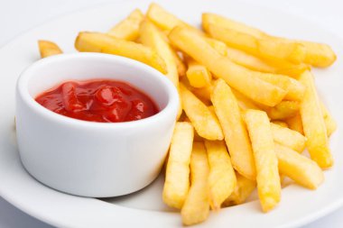 A beautiful photo of a closeup menu of fresh delicious french fries sauce on a plate on a white background