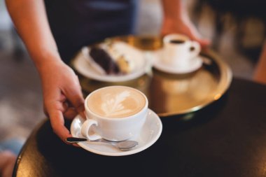 A mug of cappuccino with a picture brought by the waiter