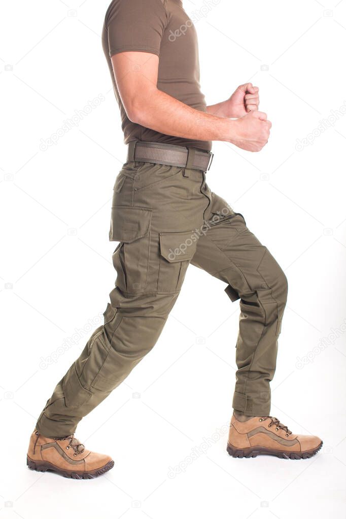 A fighter in military uniform is ready for a fight on a white background