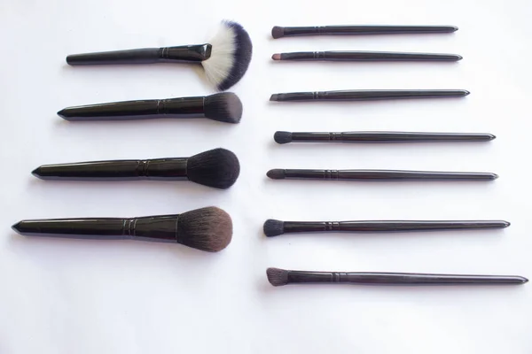 makeup brushes set isolated on white background. Top view, flat lay