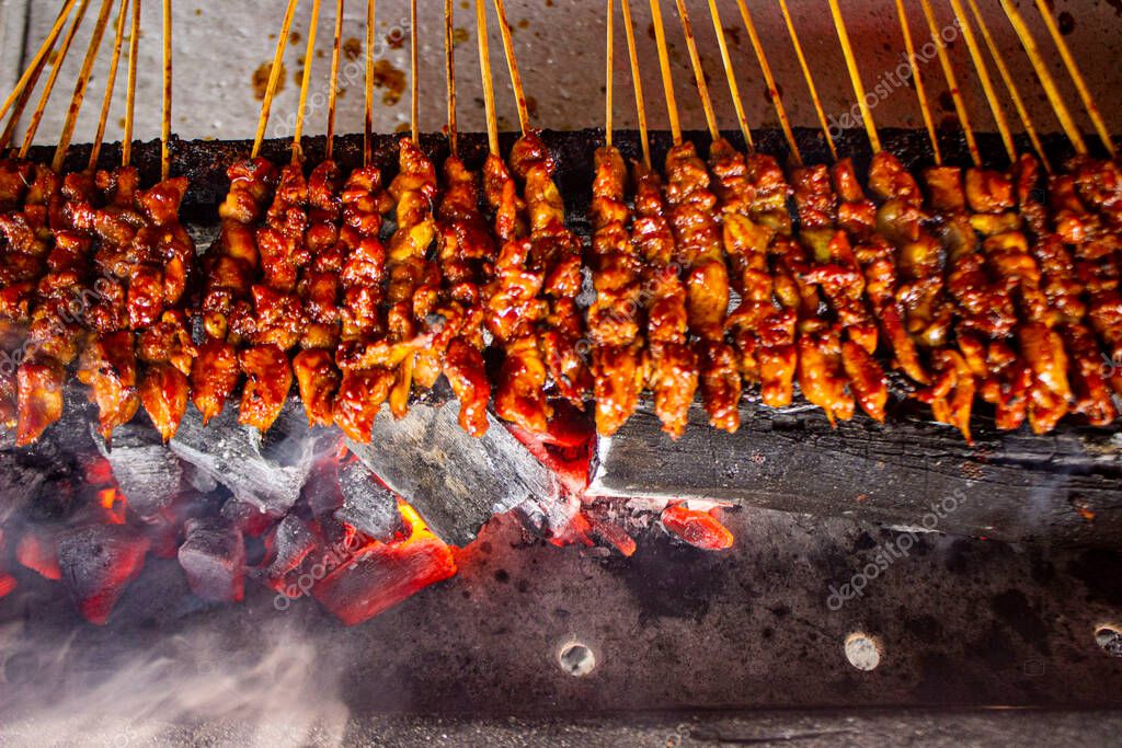 sate ayam or chicken satay with rice cake (lontong) served with peanut