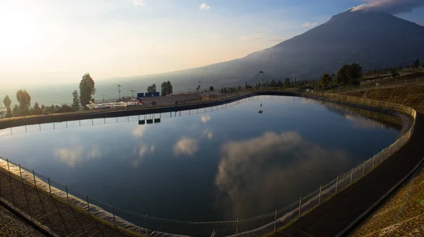 Aerial view of a rainwater retention basin in morning with foggy. retention basin bansari or embung bansari