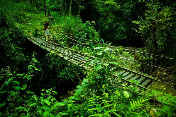 Man Crossing While Carrying Sand Bridge Made Railroad Tracks Approaching — Zdjęcie stockowe