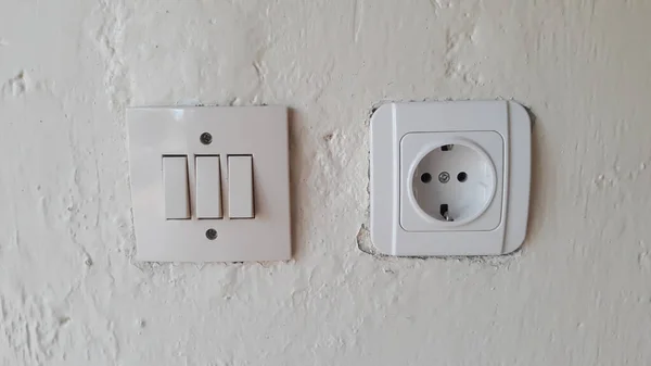 Switch and Electric socket and white wall Switch and Electric socket and white wall