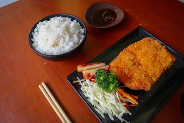 Tavuk katsu Japon yemeğidir. Masada soya sosu ile servis edilir.