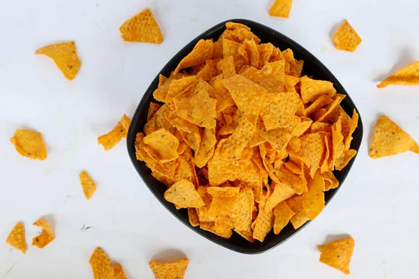 tortilla chip is corn chips or call nachos, served in bowl, on black background made from corn