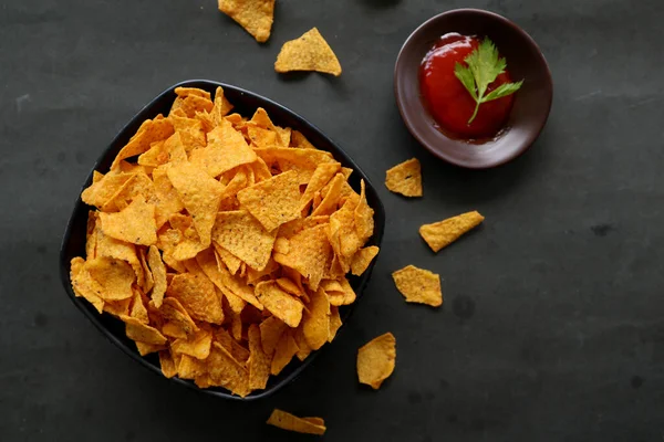 tortilla chip is corn chips or call nachos, served in bowl, on black background made from corn