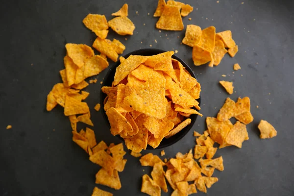 tortilla chip is corn chips or call nachos, served in bowl, on black background made from corn