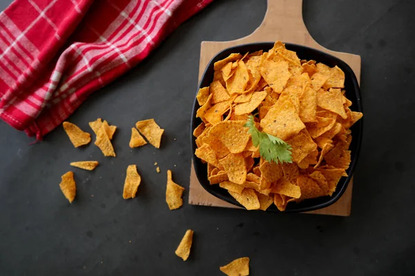 tortilla chip is corn chips or call nachos, served in bowl, on black background made from corn