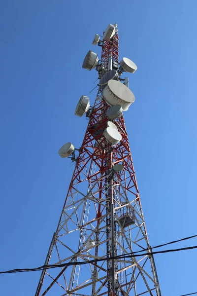 communication tower. Telco Trellis for 3G 4G 5G Apocalypse Internet Communication, mobile, FM Radio and Television Broadcasting On Air with Blue Sky in Background