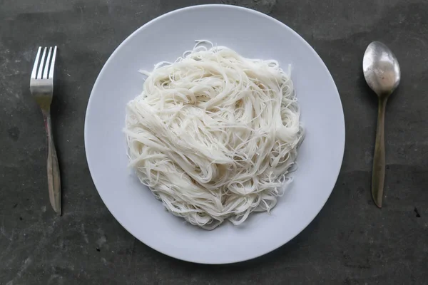 bihun or vermicelli or rice noodles or angel hair served on plate isolated on black background