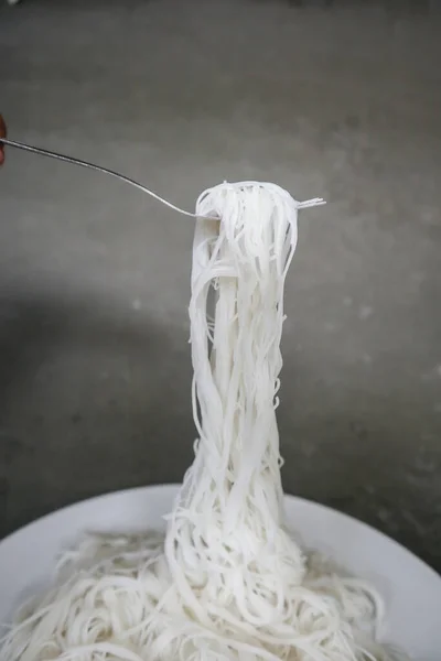 bihun or vermicelli or rice noodles or angel hair isolated on black background. served on small bowl