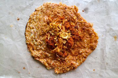 kerak telor or Egg Crust. kerak telor is Spicy Glutinous Rice Omelette with Grated Coconut. made from glutinous rice cooked, egg, serundeng, fried shallots and dried shrimp topping.