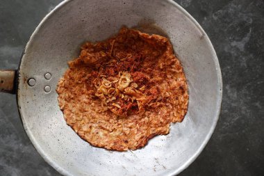 kerak telor or Egg Crust. kerak telor is Spicy Glutinous Rice Omelette with Grated Coconut. made from glutinous rice cooked, egg, serundeng, fried shallots and dried shrimp topping.