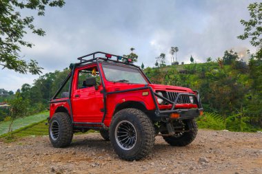 red off-road jeep car in the mountains red off-road jeep car in the mountains