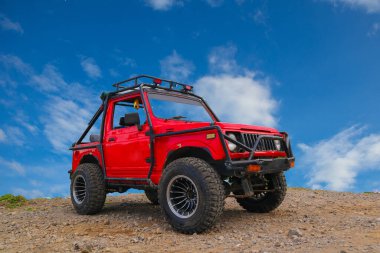red off-road jeep car in the mountains red off-road jeep car in the mountains