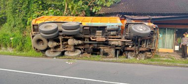 klaten, Indonesia - July 4, 2022, A large truck has an accident, it rolls over in a side ditch after a traffic accident. no victims