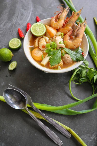 Tom yam soup originating from Thailand. Tom yum is made with shrimp, chili, lime, chicken, fish, or seafood and mushrooms.
