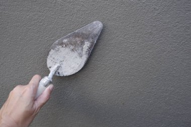 Image of a left hand of carpenter plastering