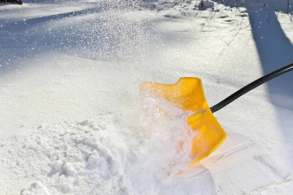 Pala di neve gialla che spala neve fresca e profonda — Foto Stock
