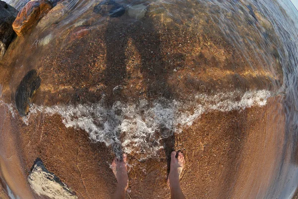 First Person Fisheye Perspective of Mans Feet in Shallow Water with Waves Rolling into Sandy Beach — Fotografia de Stock