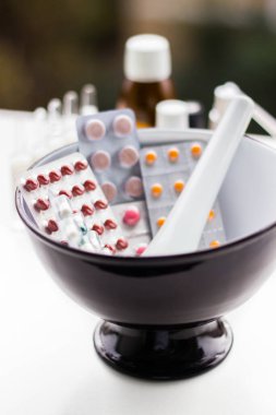 Alternatif tıp. Hap ve ilaç şişeleriyle havan topu ve tokmak