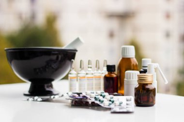 Alternatif tıp. Hap ve ilaç şişeleriyle havan topu ve tokmak