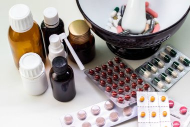 Alternatif tıp. Hap ve ilaç şişeleriyle havan topu ve tokmak