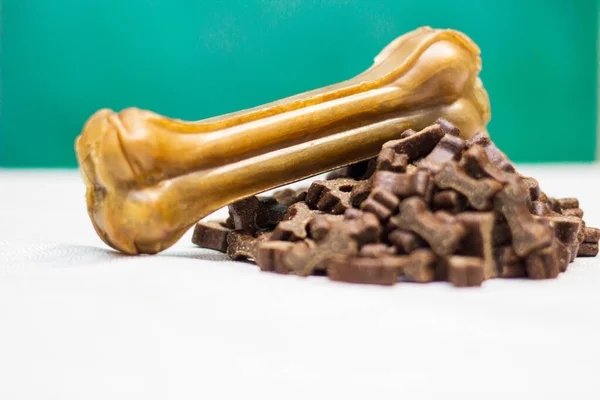 Dog bone for chewing on a green background