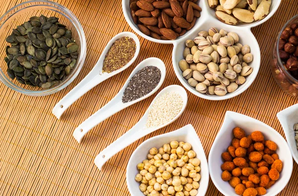 Nuts and seeds. Superfoods in Bowls on Wooden Background