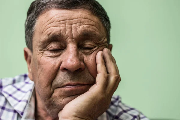Portrait of elderly man lost in thought
