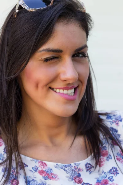 Young woman laughing, looking at camera