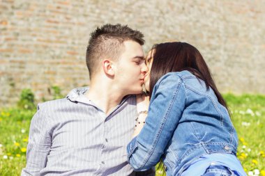 Öpüşen ve kucaklayan mutlu genç bir çiftin portresi