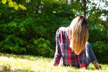 Young woman enjoying the nature view. Rear view