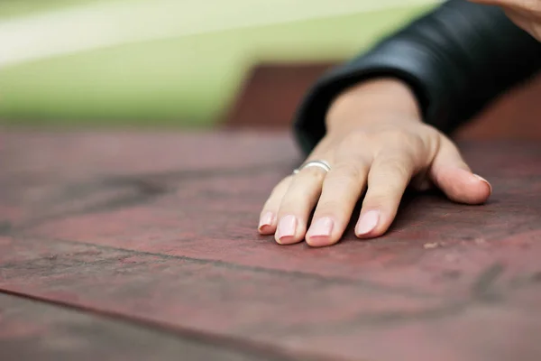 Lonely hand on table. Woman\'s hand on the table, waiting someohne