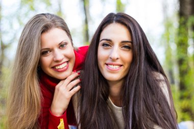 Young beautiful girl enjoying the sunny autumn day, in the park