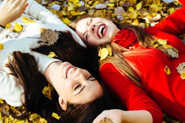 Young beautiful girl enjoying the sunny autumn day, in the park