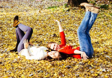 Young beautiful girl enjoying the sunny autumn day, in the park
