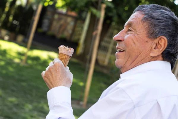 Happy senior Man eating ice cream