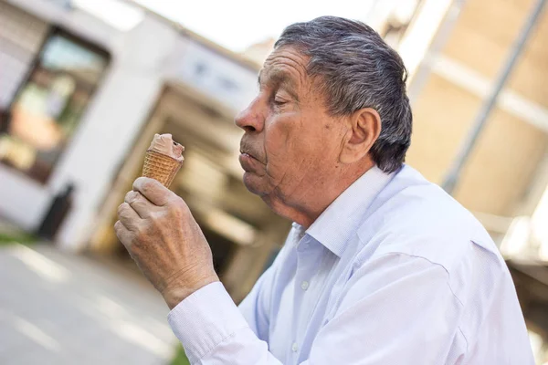 Happy senior Man eating ice cream