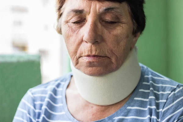 Senior woman with neck injury. Senior woman wearing neck brace