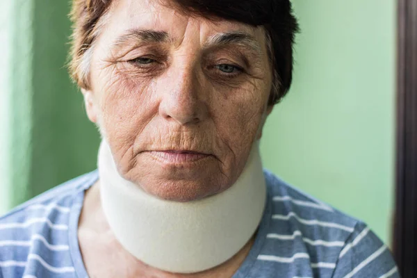 Senior woman with neck injury. Senior woman wearing neck brace
