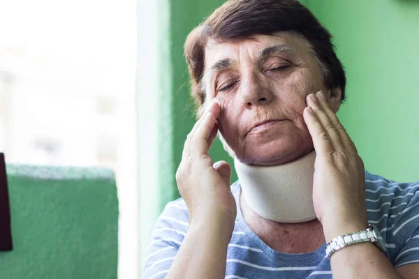 Senior woman with neck injury. Senior woman wearing neck brace